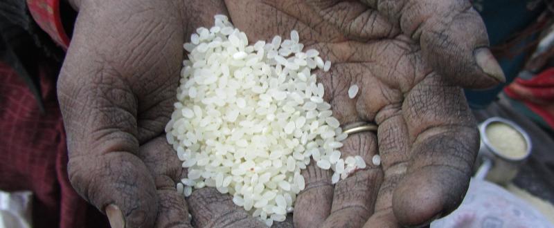 Rural woman showing the rice which was donated by the Government of Japan to Government of Nepal, and distributed by Nepal Food Corporation (NFC) in Gamgadi, Mugu district, Nepal. Photographer: Basudha Gurung